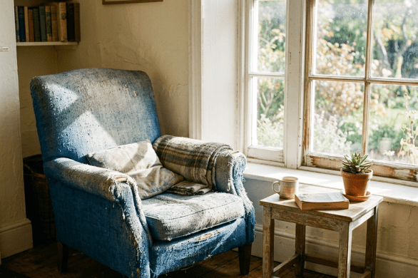 Sun-faded furniture near bright window